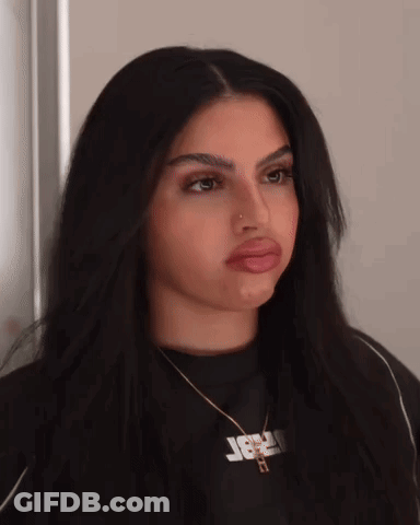 Woman With Jesus Necklace Making Funny Face GIF