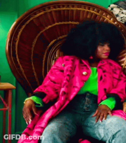 Woman With Large Afro Sitting In Chair GIF