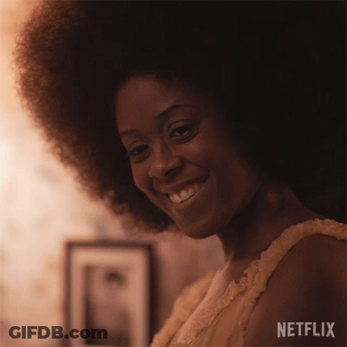 Woman With Large Afro Smiling In Netflix Ad GIF