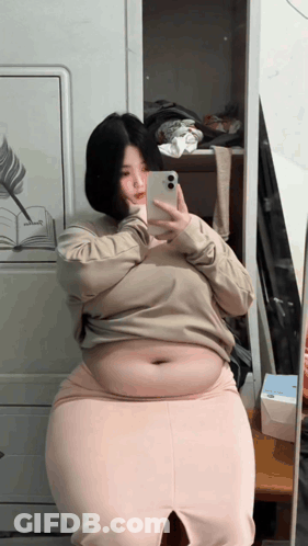 Woman With Large Belly In Black Jeans And Crop Top GIF
