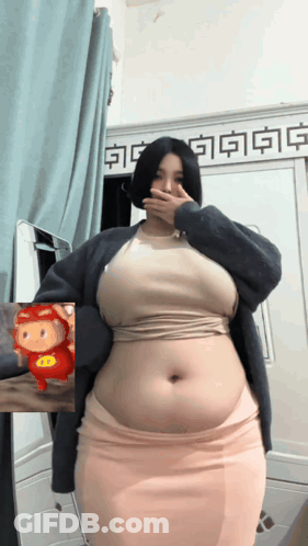Woman With Large Belly In Front Of Mirror GIF
