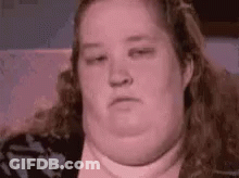 Woman With Large Belly Sitting On Couch GIF
