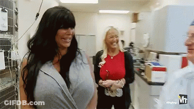 Woman With Large Breasts Standing With Two Women GIF