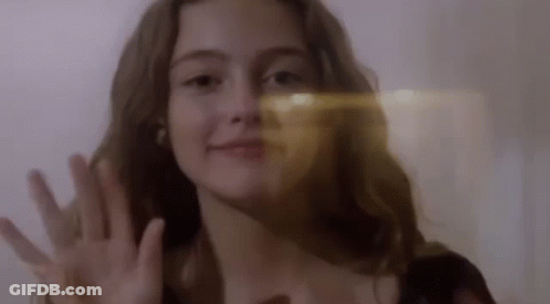 Woman With Light Shining On Face GIF