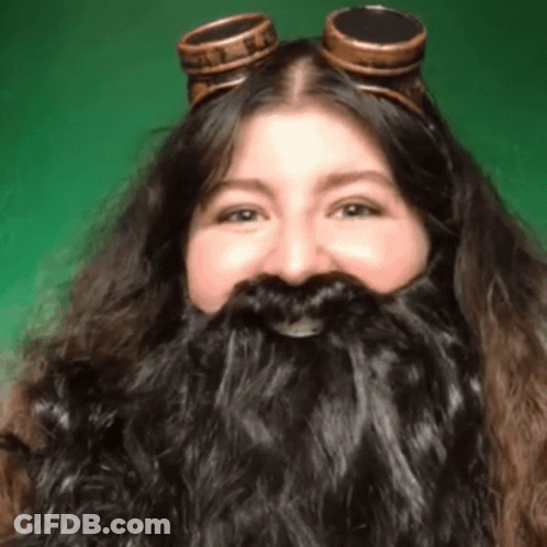 Woman With Long Beard And Goggles Smiling GIF