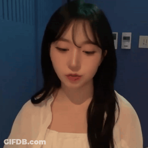 Woman With Long Black Hair And Bangs In White Shirt GIF