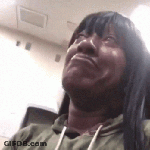 Woman With Long Black Hair And Green Hoodie Making Funny Face GIF