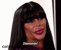 Woman With Long Black Hair And Pink Lips Saying Diamonds GIF
