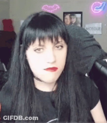 Woman With Long Black Hair And Red Lips Wearing Headphones And Choker GIF