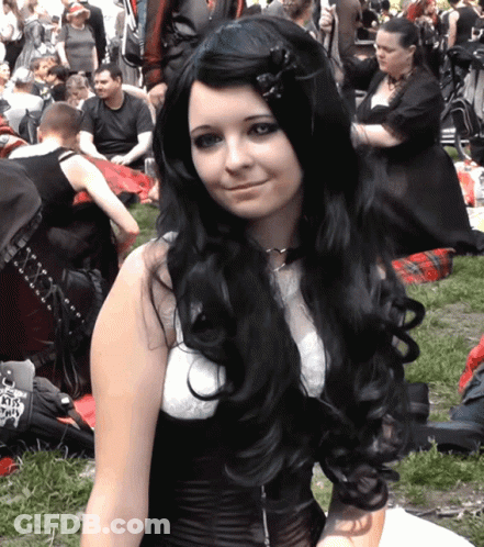 Woman With Long Black Hair And White Top Holding KTS License Plate GIF
