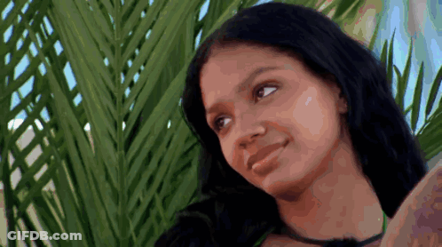 Woman With Long Black Hair Beside Palm Tree GIF