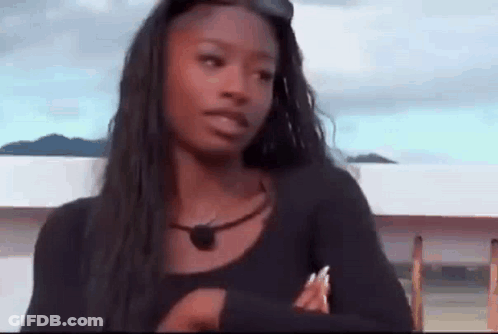 Woman With Long Black Hair Crossed Arms Looking At Camera GIF