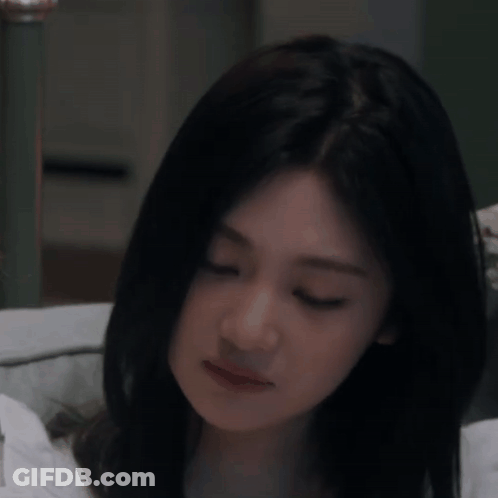 Woman With Long Black Hair Eyes Closed On Bed GIF