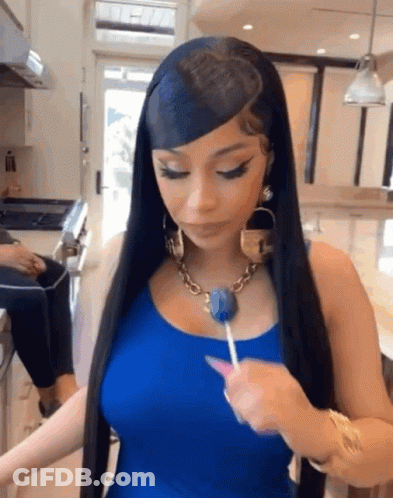 Woman With Long Black Hair Holding Lollipop GIF