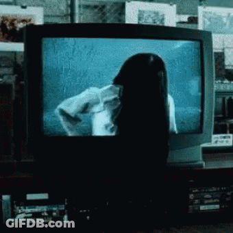 Woman With Long Black Hair In Front Of Television GIF