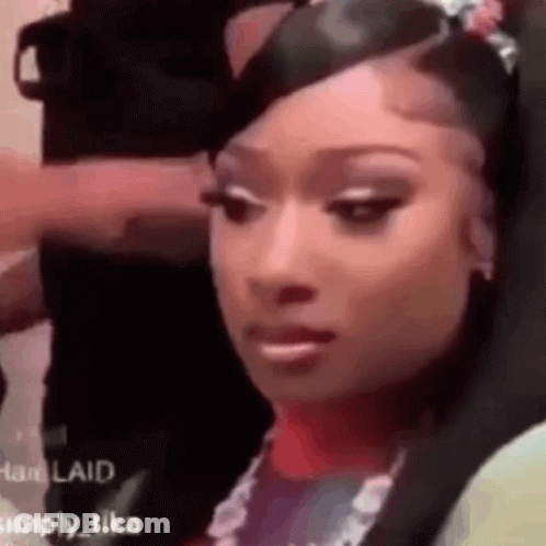 Woman With Long Black Hair In White Fur Coat Flipping Off GIF