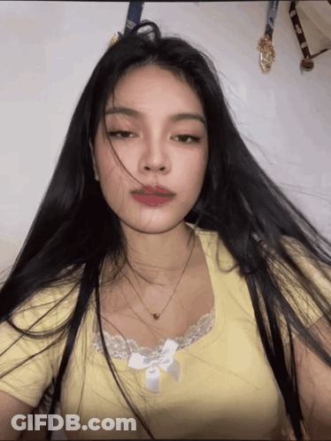 Woman With Long Black Hair In Yellow Shirt GIF