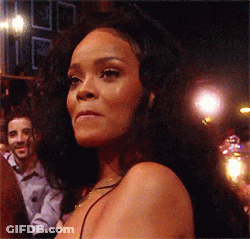 Woman With Long Black Hair Looks At Camera GIF
