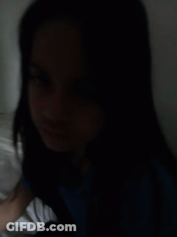 Woman With Long Black Hair Lying On Bed Eyes Closed GIF