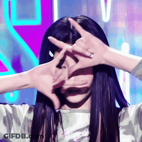 Woman With Long Black Hair Making Face With Hands GIF