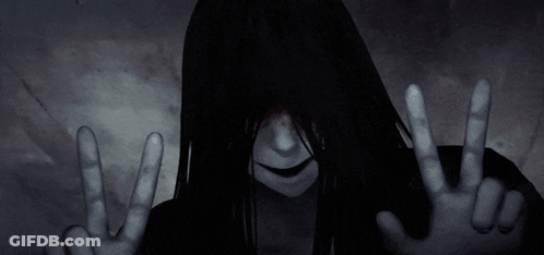 Woman With Long Black Hair Making Peace Sign GIF