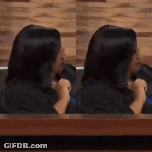 Woman With Long Black Hair Sitting At Table GIF