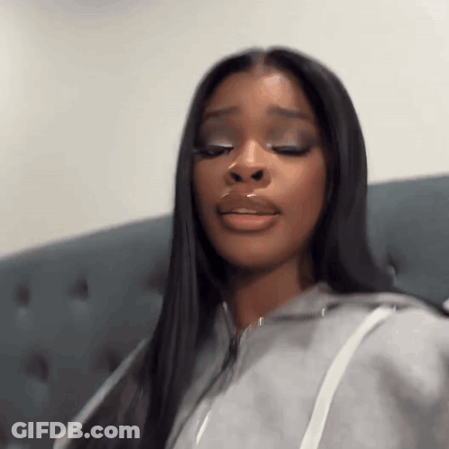 Woman With Long Black Hair Sitting On Couch Eyes Closed Mouth Open GIF