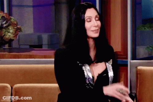 Woman With Long Black Hair Sitting On Couch GIF