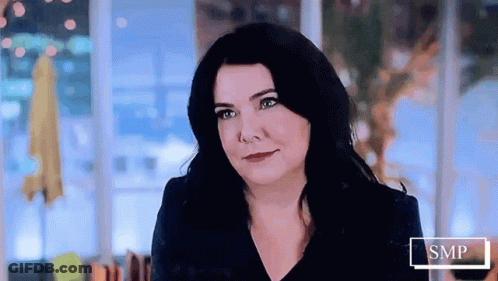 Woman With Long Black Hair Smiling At Camera GIF