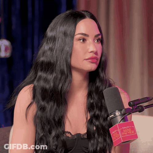Woman With Long Black Hair Talking Into Babylon Microphone GIF