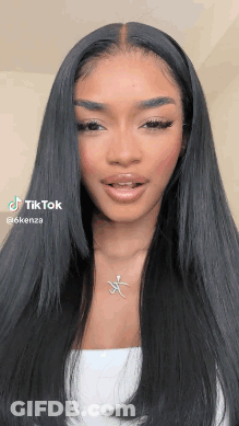 Woman With Long Black Hair Wearing White Top And Necklace GIF