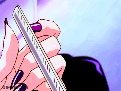 Woman With Long Black Nails Holding Ruler GIF