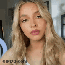 Woman With Long Blonde Hair And Pink Lips GIF