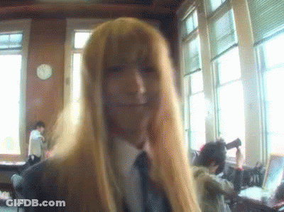 Woman With Long Blonde Hair And Tie Smiling GIF