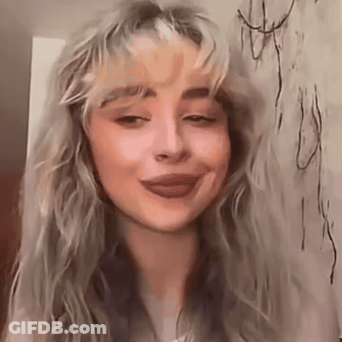Woman With Long Blonde Hair And Wall Drawing GIF