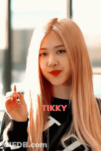 Woman With Long Blonde Hair In Black Tikky Shirt GIF