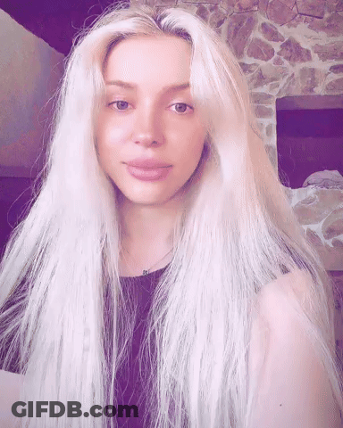 Woman With Long Blonde Hair In Black Top GIF