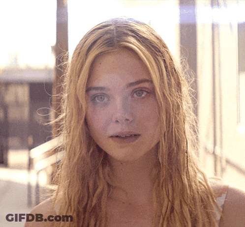 Woman With Long Blonde Hair Looking At Camera GIF