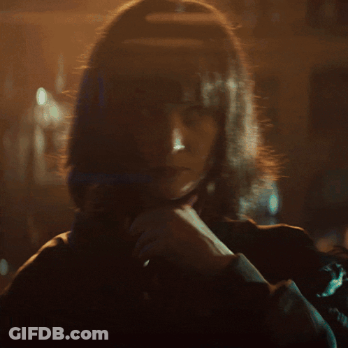 Woman With Long Blonde Hair Looking At Camera GIF