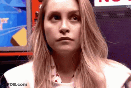 Woman With Long Blonde Hair Making Funny Face In Front Of Computer Monitor GIF