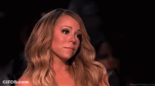 Woman With Long Blonde Hair Sitting In Dark Room Eyes Closed GIF