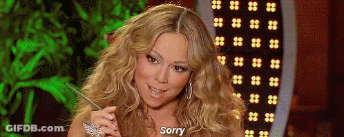 Woman With Long Blonde Hair Sitting In Front Of Green Screen Saying Sorry GIF