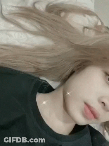Woman With Long Blonde Hair Taking Selfie In Bed GIF