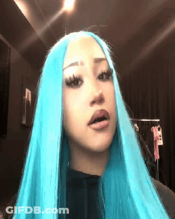 Woman With Long Blue Hair Looking At Camera GIF
