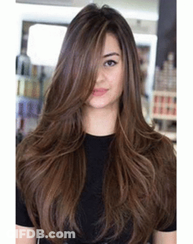 Woman With Long Brown Hair And Black Shirt In Salon GIF
