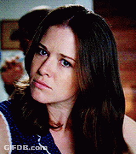 Woman With Long Brown Hair In Blue Polka Dot Top GIF