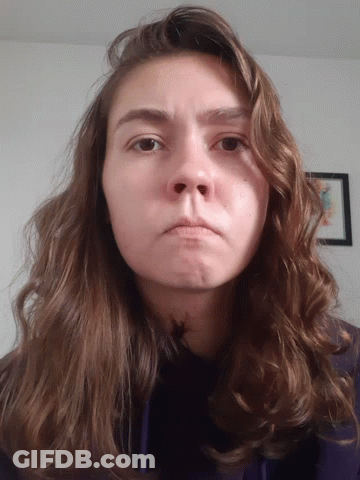 Woman With Long Brown Hair Making Face GIF