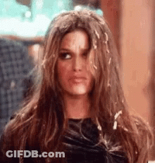 Woman With Long Brown Hair Making Funny Face Hand To Face GIF