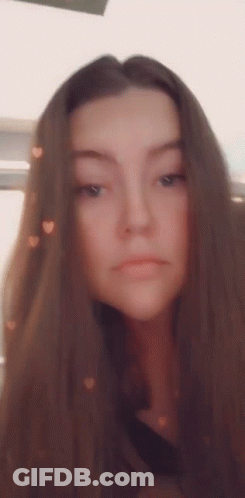 Woman With Long Brown Hair Taking Selfie With Hearts GIF