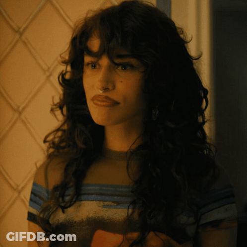 Woman With Long Curly Hair In Striped Shirt GIF